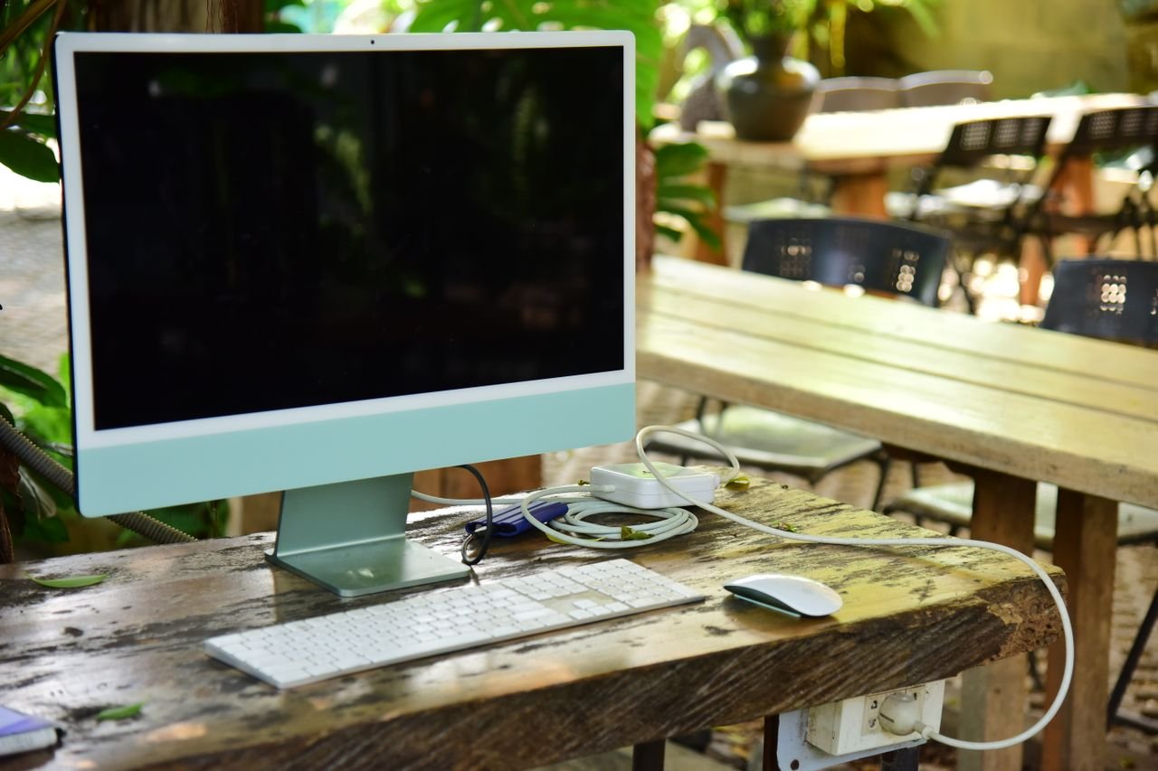 About Modern computer setup on a rustic table outdoors, perfect for remote work.
